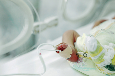 Infant sleeping in incubator