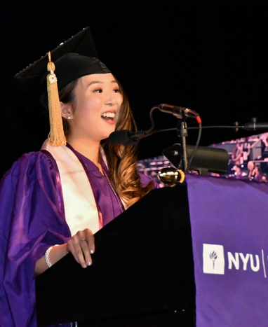 Graduate speaking at podium 